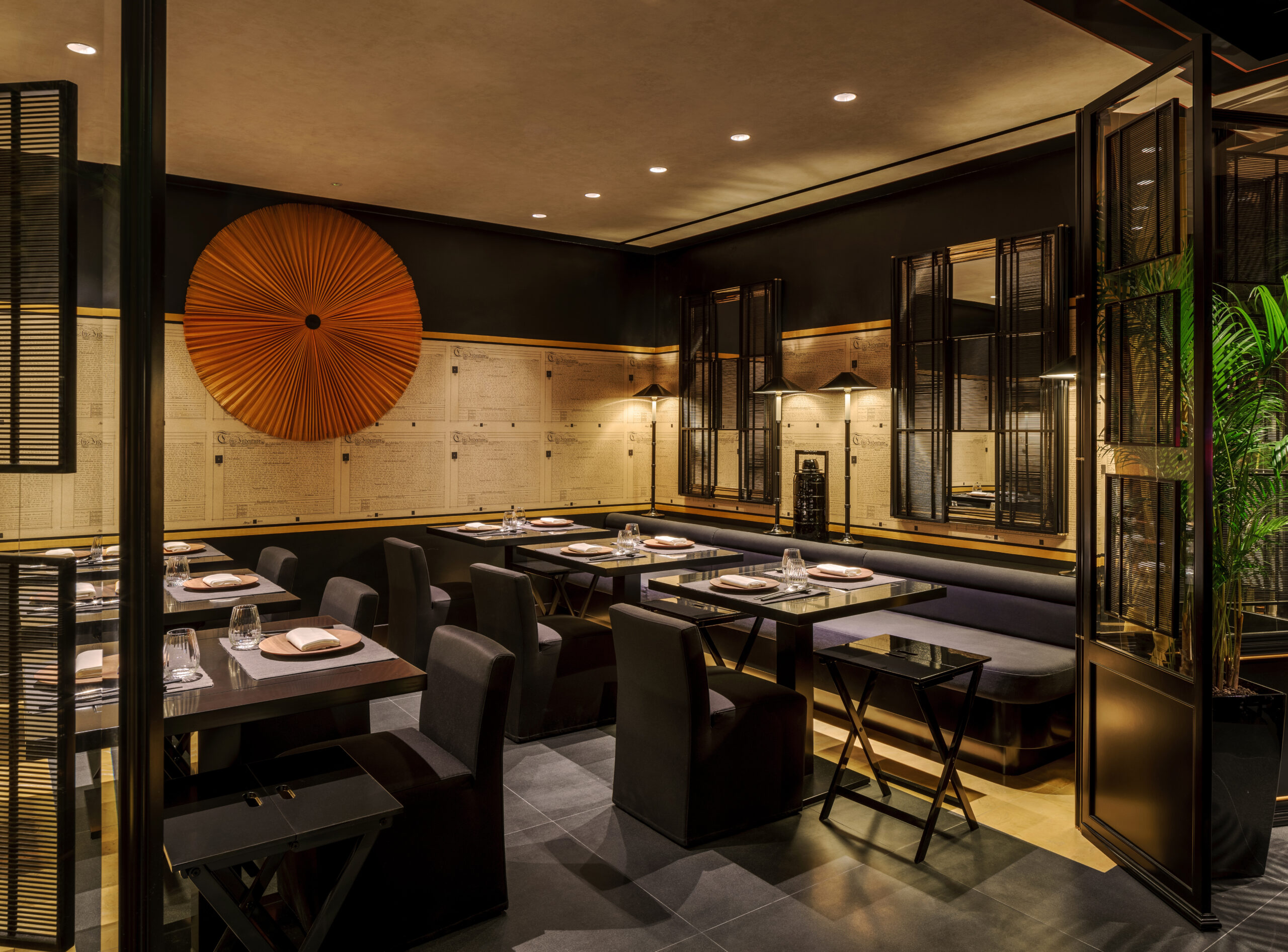 Elegant restaurant interior at Yellow Pot Tanjong Pagar featuring sophisticated dark decor, ambient lighting, and modern dining tables.